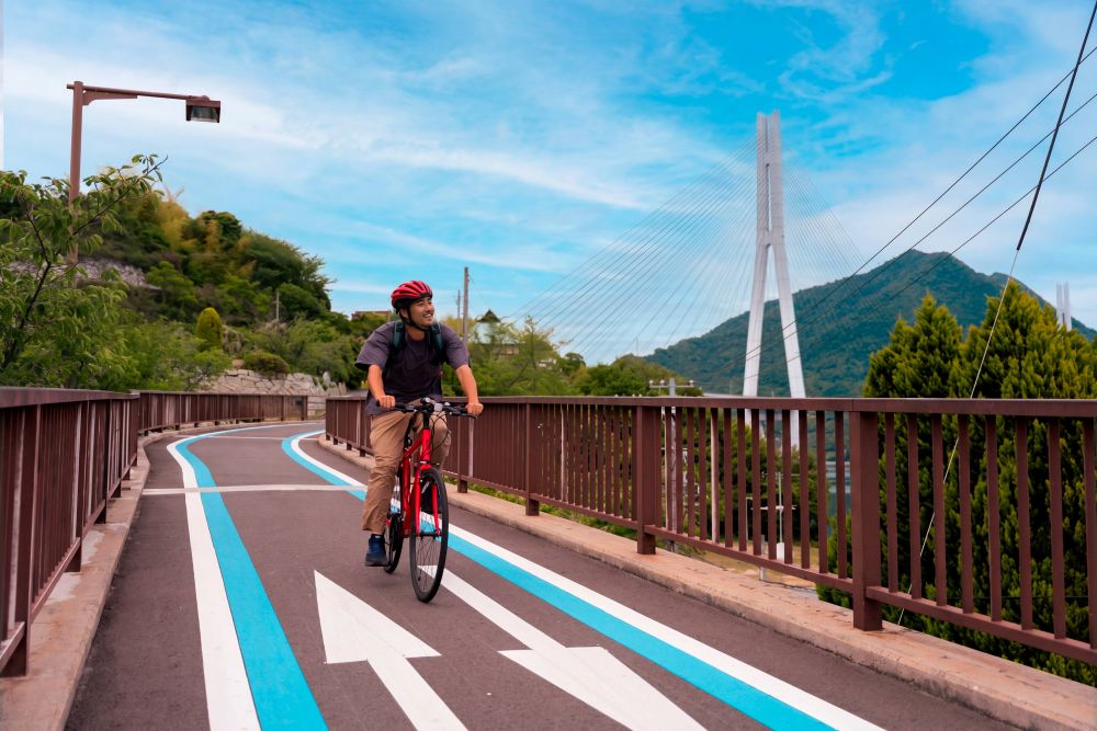Cyclist crossing a Shimanami Kaido suspension bridge over the Seto Inland Sea